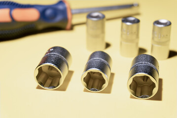 Hexagon socket wrenches, on yellow background. Mechanics and DIY concept.