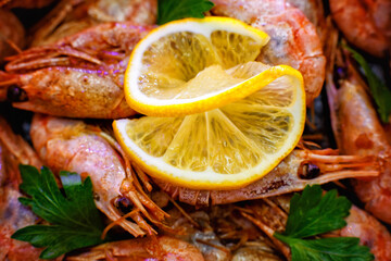 Selective focus. Close-up of shrimp with lemon on a wooden background