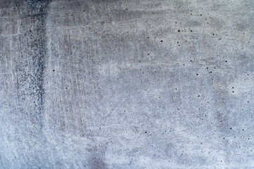 Concrete beton brut grunge wall or floor texture. Weathered cement with pores for modern interior...