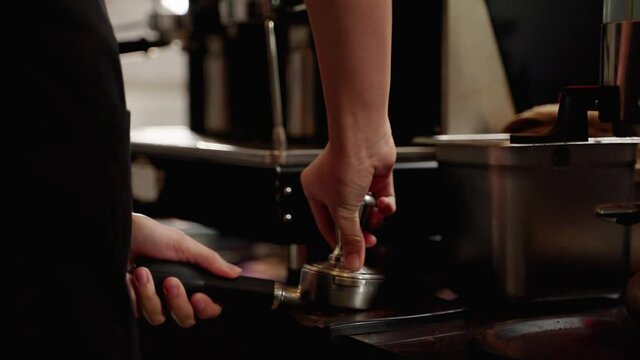Barista making hot coffee in coffee shop. Process of making hot coffee in a coffee machine. business concept, small business, startup business
