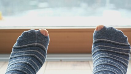 Careless Poor Caucasian Male Moving Feet Wearing Worn Out Socks with Toe Holes  © rohawk