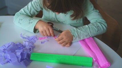 Smart Creative Caucasian Girl Preparing Art Project for Elementary School using Colorful Blotting Tissue Paper and Paper Glue	