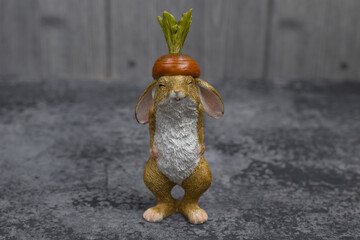 Rabbit on a gray background. Easter bunny for design or greeting card in honor of the symbol of the new year of the rabbit. Selective focus.