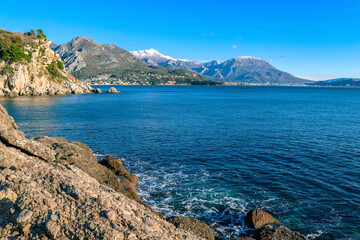 Nice view of the Adriatic Sea, mountains and the city of Sutomore in Montenegro, Balkans. Winter, snow in the mountains. Maljevik beach.