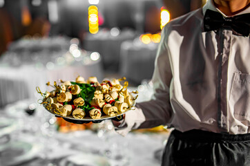 waiter holds tray with food. Restaurant service. buffet or catering.