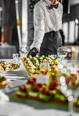 waiter holds tray with food. Restaurant service. buffet or catering.