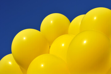  yellow balloons in the city festival against deep blue sky
