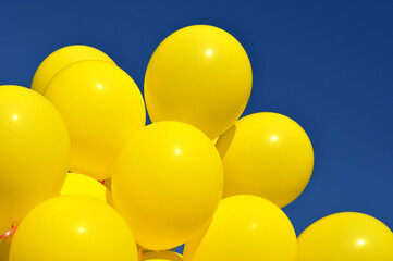 yellow balloons in the city festival against deep blue sky