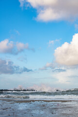 Fototapeta na wymiar Crushing ocean waves. Scenic sky and tranquil beach line