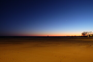Lighthouse in the distance at dusk 