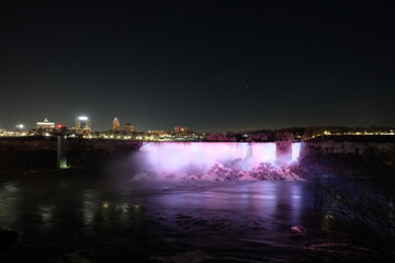 Fototapeta na wymiar American Falls, Bridal Veil Falls, Niagara Falls at night, with light pointing at it