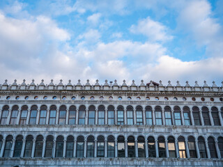 Fototapeta na wymiar Procuratie vecchie, facade of the famous palace landmark in Piazza San Marco, Venice, Italy