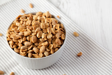 Roasted Salted Shelled Peanuts, side view. Space for text.