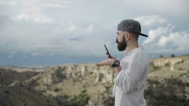 Slow Motion of Young Man Talking On His Smartphone in Matera. Italy