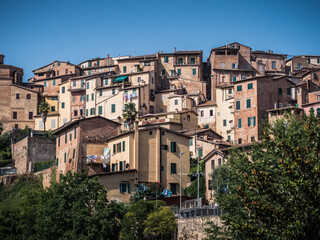 Fototapeta na wymiar Siena Cityscape with Medieval Residential Houses of the Historic Old Town Center Perched on a Hill in Tuscany