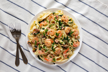 Homemade Shrimp Spinach Bacon Alfredo on a Plate, top view. Flat lay, overhead, from above.