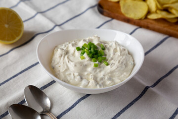 Homemade Clam Dip with Potato Chips, low angle view.