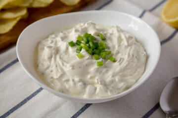 Homemade Clam Dip with Potato Chips, side view. Close-up.