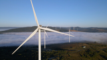 Wind farm in the morning fog. Aerial photography