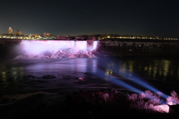 American Falls, Bridal Veil Falls, Niagara Falls at night, with light pointing at it
