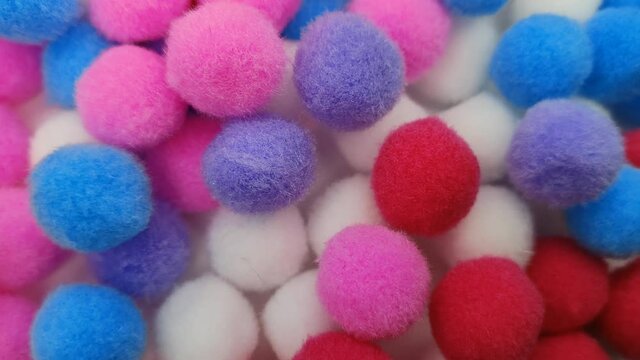 Set of multicolored pompons for needlework. Close-up, rotation.