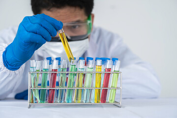 chemical researcher, scientist Functional analysis with multicolored liquid test tubes in the...