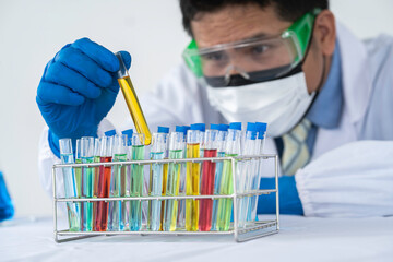 chemical researcher, scientist Functional analysis with multicolored liquid test tubes in the...