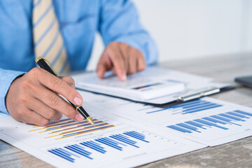 businesswoman or accountant using calculator to calculate calculate business data, working at office, accountancy document and laptop computer on office table, business and finance concept