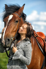 Fototapeta premium teenager girl with a horse in the field