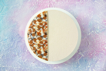 Winter Christmas cake in white with decor on top and copy space - a beautiful view from above on the table with a dessert of white chocolate and velour with frosty streaks