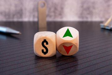 Wooden cubes changes the direction of an arrow symbolizing that the dollar are going down or vice...