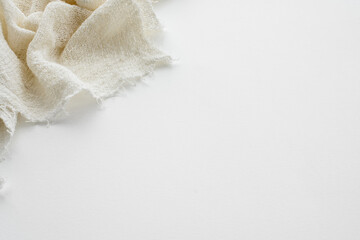 Top view of a white table and a cotton eco-friendly napkin.  Kitchen background.