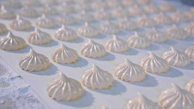 Industrial production of sweets . Marshmallow moving slowly along the conveyor. Desserts factory making.