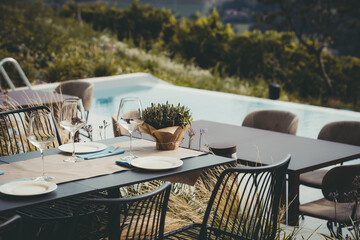 Table setting with elegant tableware and decorative plants ready for the open-air event
