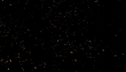 Gold sparkled carnival confetti on black background