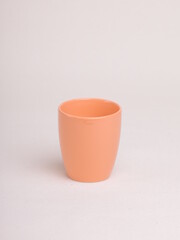 orange tea cup on a light background