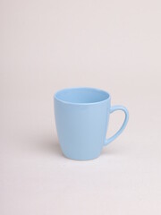 blue ceramic coffee mug on a light background