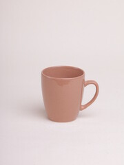brown ceramic coffee mug on a light background