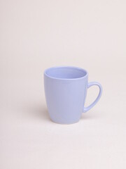 purple ceramic coffee mug on a light background