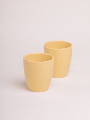 yellow ceramic cup on a light background