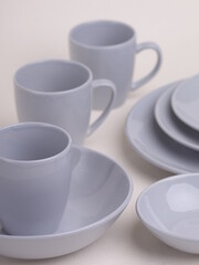 set of gray ceramic dishes on a light background
