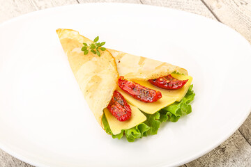 Pancake with cheese and dry tomato