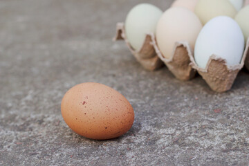 farm colorful eggs on a grey stone background