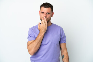 Young Brazilian man isolated on white background covering mouth with hand