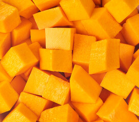 textured diced butternut squash close up. - obrazy, fototapety, plakaty