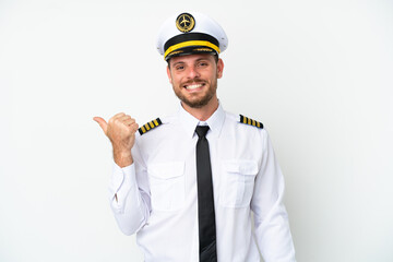 Airplane Brazilian pilot isolated on white background pointing to the side to present a product