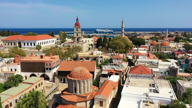 The Suleyman Mosque in the old town of Rhodes, Rhodes island, Greece. Medieval Clock Tower (Roloi Clock Tower) in the city of Rhodes in Rhodes island in Greece.