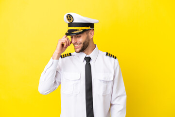 Airplane caucasian pilot isolated on yellow background laughing