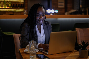 Businessman working on his laptop while drinking coffee in a cafe