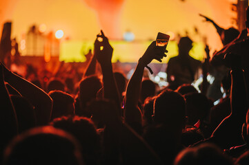 Man hand taking picture in a concert on a music festival